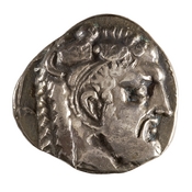 Obverse 'SilCoinCy A7695, acc.no.: 1944.100.58065. Silver coin of king Evagoras I of Salamis 411 - 374 BC. Weight: 10.526g, Axis: 9h, Diameter: -. Obverse type: Heracles hd. r.. Obverse symbol: -. Obverse legend: - in Cypriot syllabic. Reverse type: goat lying r.. Reverse symbol: -. Reverse legend: pa-si-le-wo-se / E Y in Cypriot syllabic + Greek.