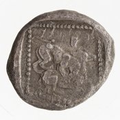 Reverse 'SilCoinCy A7050, Gift of Christian G. Gunther. March 1949, acc.no.: 1951.116.80. Silver coin of king Baalmilk II of Kition 425 - 400 BC. Weight: 10.47g, Axis: 4h, Diameter: 21mm. Obverse type: Heracles advancing r. holding club and bow. Obverse symbol: -. Obverse legend: - in -. Reverse type: lion devouring stag r. within incuse square. Reverse symbol: -. Reverse legend: lb'lmlk in Cypriot syllabic.