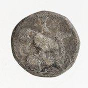 Reverse 'SilCoinCy A7059, Gift of Christian G. Gunther. March 1949, acc.no.: 1951.116.83. Silver coin of king Baalmilk II of Kition 425 - 400 BC. Weight: 10.715g, Axis: 3h, Diameter: 19mm. Obverse type: Heracles advancing r. holding club and bow. Obverse symbol: -. Obverse legend: - in -. Reverse type: lion devouring stag r.. Reverse symbol: -. Reverse legend: [b'lmlk] in Phoenician.