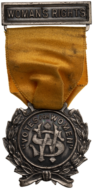 Figure 1: “Votes for Women” badge worn by suffragettes. (ANS 1919.83.106, gift of J. Sanford Saltus, https://numismatics.org/collection/1919.83.106)